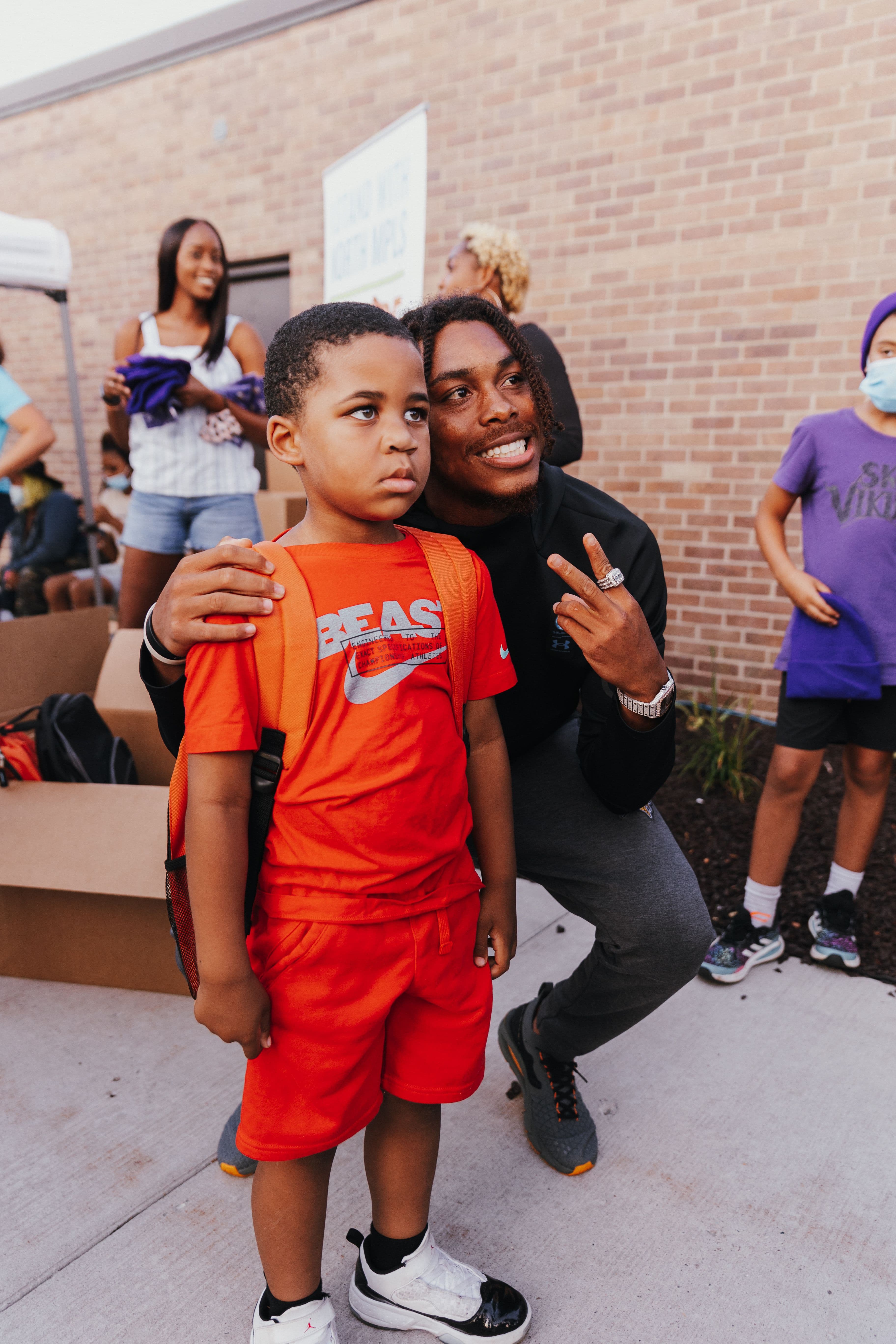 Justin Jefferson with a young boy at the Backpack Drive