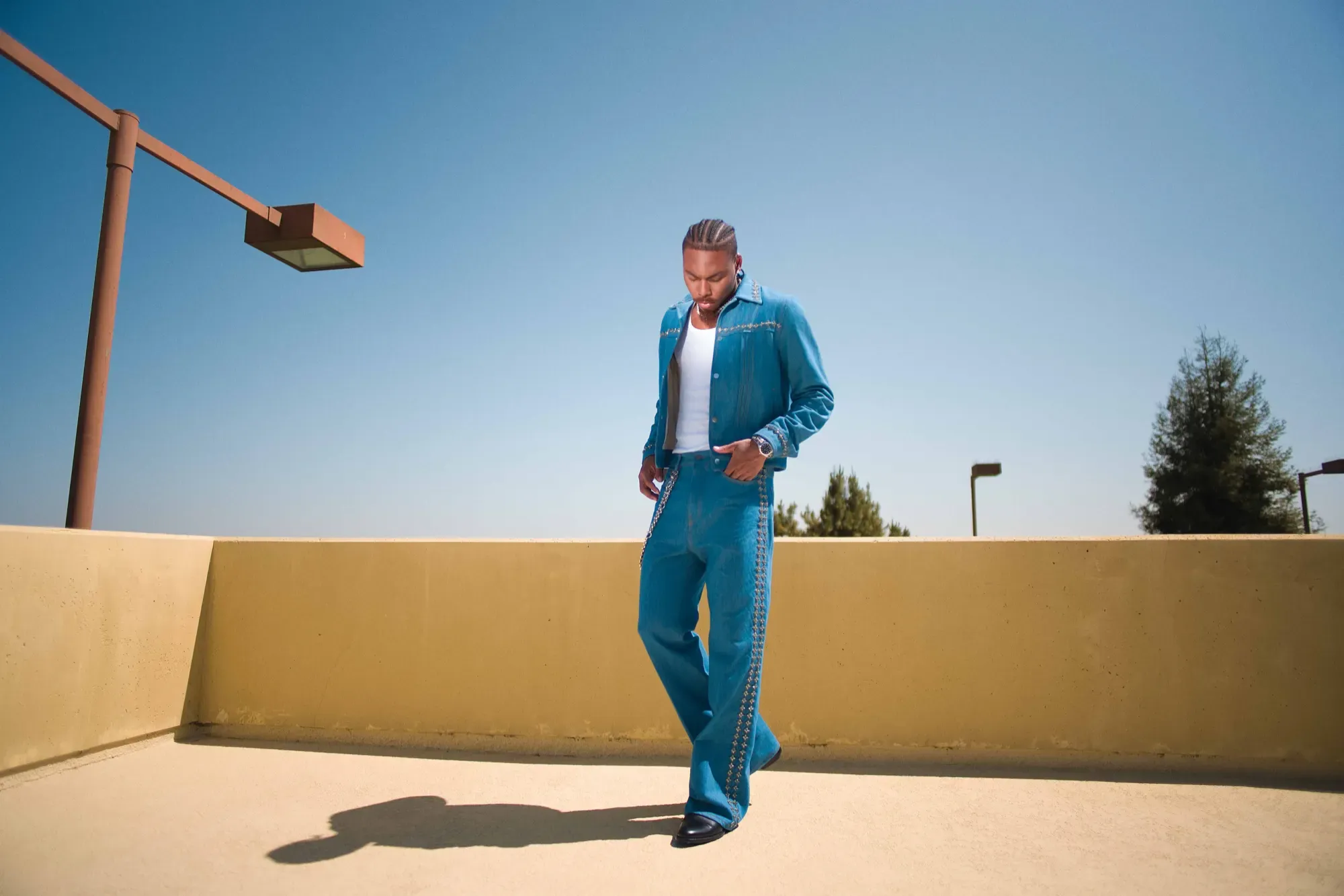 Justin Jefferson in a full denim fit on a rooftop parking deck